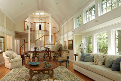Example of a large classic formal and enclosed medium tone wood floor living room design in Boston with beige walls, no tv and a standard fireplace