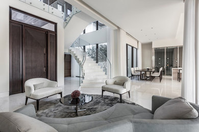 Living room - contemporary open concept white floor living room idea in Miami with white walls