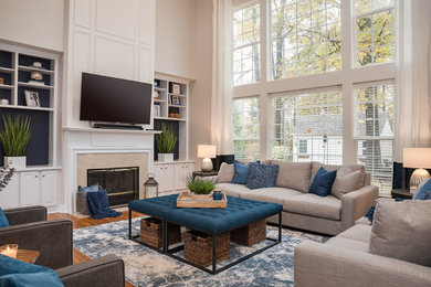 Example of a large transitional formal and open concept bamboo floor and brown floor living room design in Charlotte with gray walls, a standard fireplace, a tile fireplace and a wall-mounted tv