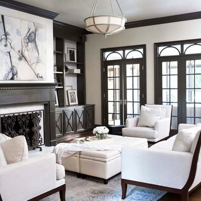 Example of a large classic enclosed dark wood floor living room design in Other with white walls, a standard fireplace and no tv
