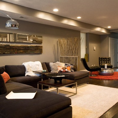 Example of a large minimalist formal and open concept dark wood floor living room design in Chicago with no fireplace, a media wall and gray walls