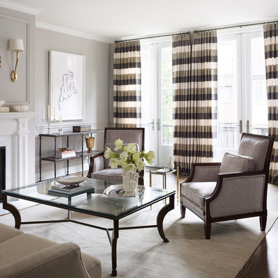 Inspiration for a large timeless formal and enclosed medium tone wood floor and brown floor living room remodel in Chicago with gray walls, a standard fireplace and a stone fireplace