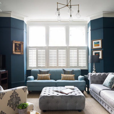 Inspiration for a transitional formal living room remodel in London with blue walls and a standard fireplace