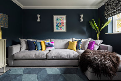 Mid-sized transitional enclosed carpeted and gray floor living room photo in Surrey with blue walls