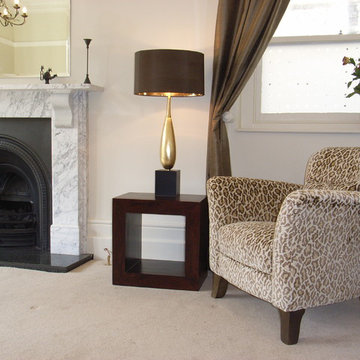 classic armchair in animal print fabric with marble fireplace