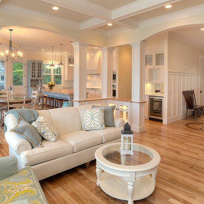 Example of a classic open concept coffered ceiling living room design in Other with beige walls