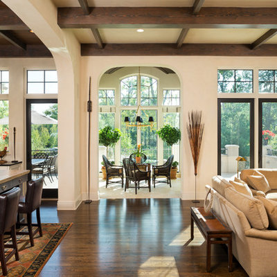 Living room - large traditional open concept dark wood floor living room idea in Minneapolis with beige walls, a standard fireplace, a stone fireplace and a concealed tv