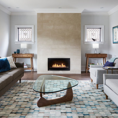 Example of a mid-sized minimalist formal and enclosed brown floor and dark wood floor living room design in Toronto with a stone fireplace, no tv, gray walls and a standard fireplace