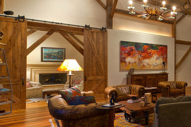 Large country enclosed medium tone wood floor living room photo in Bridgeport with beige walls