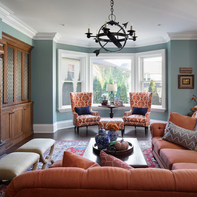 Living room - traditional open concept dark wood floor and brown floor living room idea in Milwaukee with green walls, a standard fireplace and a tile fireplace