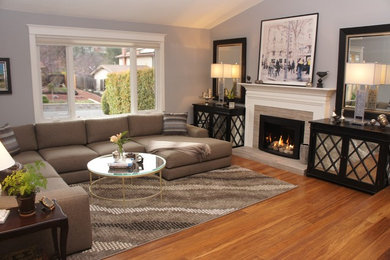 Living room - mid-sized traditional medium tone wood floor and brown floor living room idea in San Francisco with gray walls, a standard fireplace and no tv