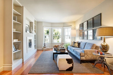 Example of a mid-sized transitional loft-style medium tone wood floor living room design in Minneapolis with white walls, a standard fireplace and a tile fireplace