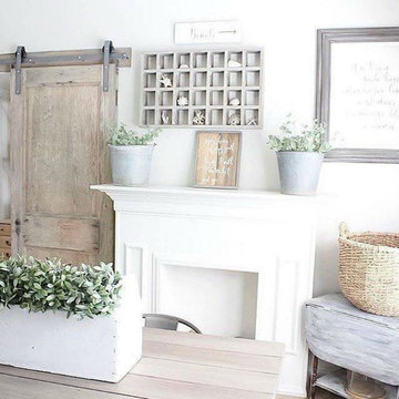 Clean White Living Room With Raw Steel Barn Door Hardware