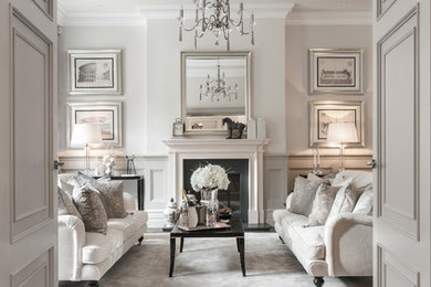 Inspiration for a traditional enclosed living room in Berkshire with dark hardwood flooring, a standard fireplace, brown floors and feature lighting.