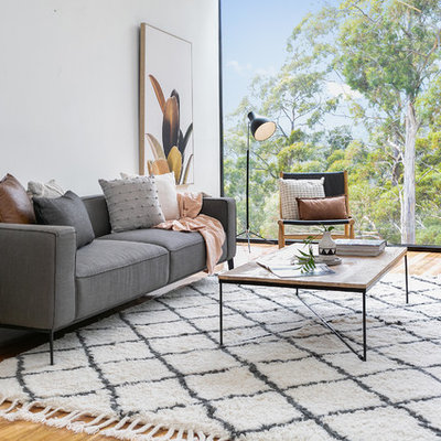 Example of a large trendy open concept medium tone wood floor and brown floor living room design in Hobart with white walls