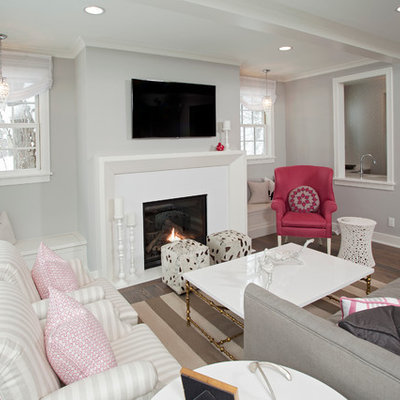 Living room - mid-sized coastal enclosed living room idea in Minneapolis with gray walls, a standard fireplace and a wall-mounted tv