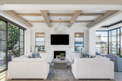 Living room - coastal open concept light wood floor and beige floor living room idea in Orange County with white walls, a standard fireplace, a brick fireplace and a wall-mounted tv