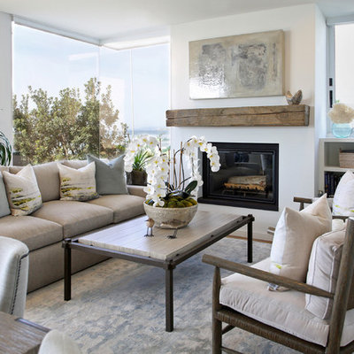 Example of a mid-sized transitional formal and open concept dark wood floor and brown floor living room design in Santa Barbara with white walls, a standard fireplace, a plaster fireplace and no tv