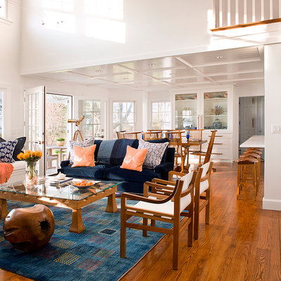 Inspiration for a coastal open concept medium tone wood floor and brown floor living room remodel in Bridgeport with white walls