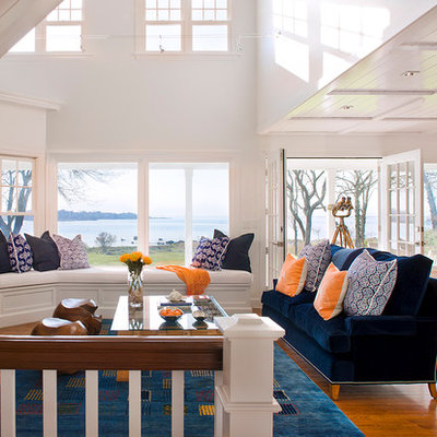 Example of a beach style open concept medium tone wood floor living room design in Bridgeport with white walls, a standard fireplace, a stone fireplace and no tv