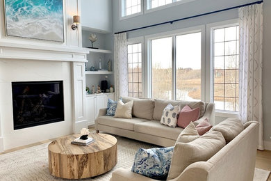 Inspiration for a large coastal open concept light wood floor and beige floor living room remodel in Calgary with gray walls, a standard fireplace and a stone fireplace