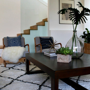 Coastal Modern Living Room with Batik Pillows and Vintage Demijohn