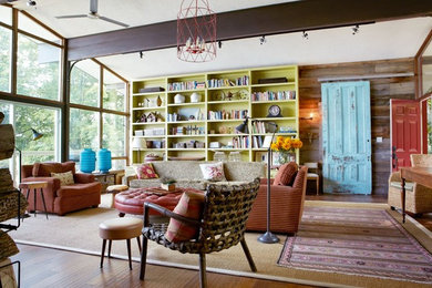 Large eclectic open concept medium tone wood floor and brown floor living room photo in Toronto with brown walls