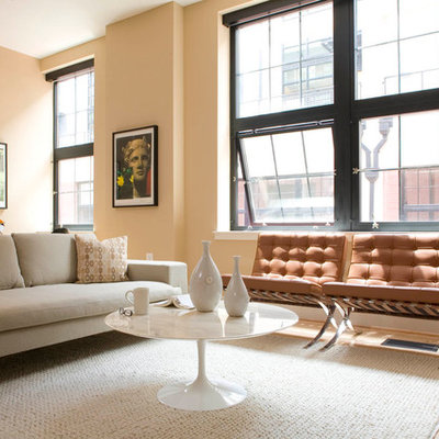 Example of a trendy light wood floor living room design in DC Metro with beige walls