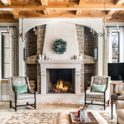 Example of a large classic formal and open concept light wood floor living room design in Nashville with beige walls, a standard fireplace, a stone fireplace and a tv stand