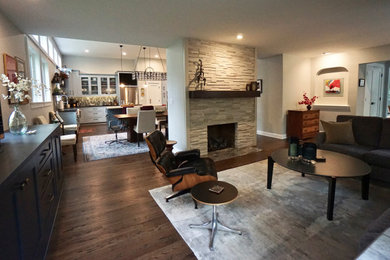 Living room - large contemporary open concept dark wood floor and brown floor living room idea in Columbus with gray walls, a stone fireplace and a media wall