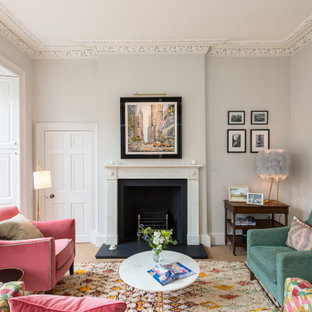 This is an example of a classic living room in Other with grey walls, carpet, a standard fireplace and beige floors.