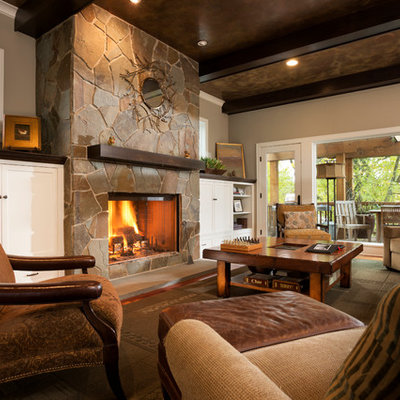 Large elegant open concept dark wood floor living room photo in Minneapolis with gray walls, a standard fireplace and a stone fireplace