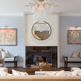 This is an example of a medium sized classic formal open plan living room in London with blue walls, dark hardwood flooring, a standard fireplace, a stone fireplace surround and brown floors.
