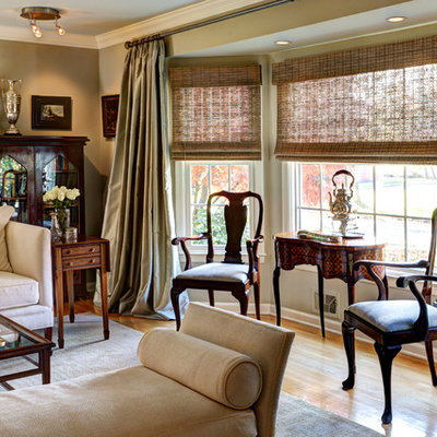 Example of a classic formal light wood floor and brown floor living room design in New York with beige walls