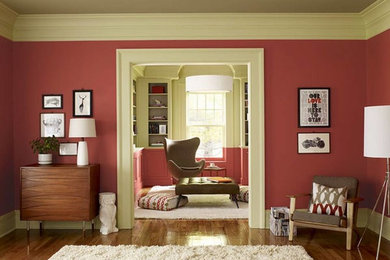 Inspiration for a mid-sized transitional formal and enclosed medium tone wood floor living room remodel in New York with red walls