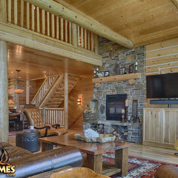 Concealed TV next to fireplace,round log beams railing posts