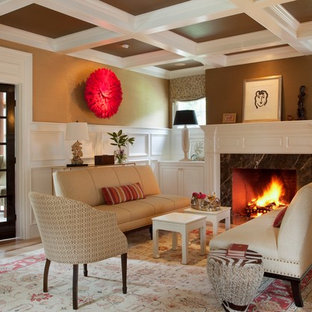 Example of a mid-sized transitional living room design in Boston with brown walls and a standard fireplace