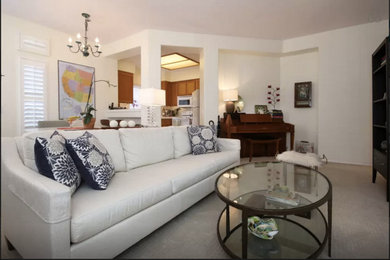 Living room - small traditional formal and open concept carpeted living room idea in San Diego with yellow walls, a standard fireplace, a wood fireplace surround and a tv stand