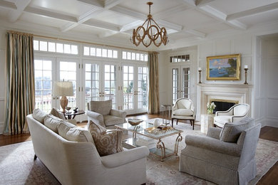 Example of a large transitional formal and enclosed medium tone wood floor living room design in Atlanta with white walls, a standard fireplace, a wood fireplace surround and no tv