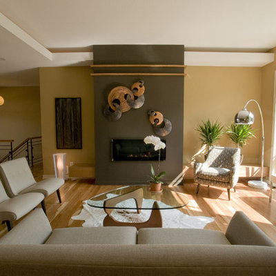 Inspiration for a contemporary living room remodel in Minneapolis with yellow walls and a ribbon fireplace