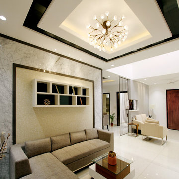 Contemporary Art Deco style entry and living room with black and gold accents
