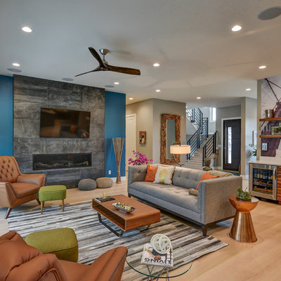 Large trendy open concept light wood floor living room photo in Indianapolis with a bar, a standard fireplace, a tile fireplace and a wall-mounted tv