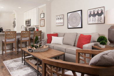 Example of a small trendy open concept laminate floor living room design in Atlanta with gray walls and a tv stand