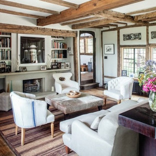 Inspiration for a medium sized rustic enclosed living room in London with white walls, dark hardwood flooring, brown floors, a standard fireplace and a stone fireplace surround.