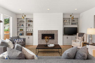 Large trendy living room photo in New York with a standard fireplace, a tile fireplace and a tv stand