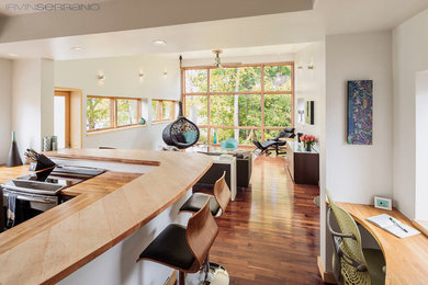 Modern enclosed living room in Portland Maine with a home bar, white walls, dark hardwood flooring, no fireplace and no tv.