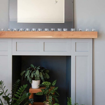 Contemporary light grey living room with fireplace