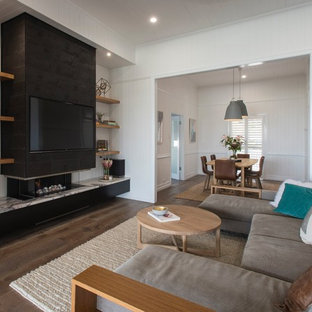 Design ideas for a contemporary living room in Brisbane with white walls, medium hardwood floors, a wall-mounted tv, a ribbon fireplace and brown floor.
