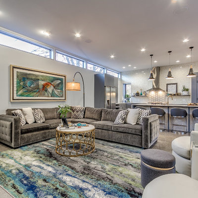 Example of a mid-sized trendy open concept concrete floor and gray floor living room design in Oklahoma City with white walls