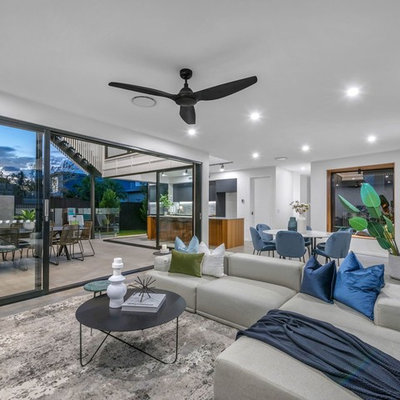 Example of a trendy open concept gray floor living room design in Brisbane with white walls
